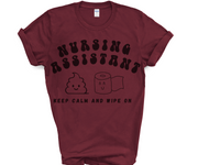 maroon tshirt for nursing assistant with words nursing assistant in black bubble font and stool and toilet paper emoji with smiley faces and the words keep calm and wipe on underneath